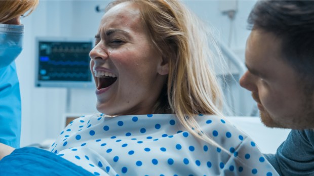 web3-in-the-hospital-close-up-shot-of-a-shouting-woman-in-labor-pushing-hard-to-give-birth-modern-maternity-hospital-with-professional-midwives-shutterstock_1181843038.jpg