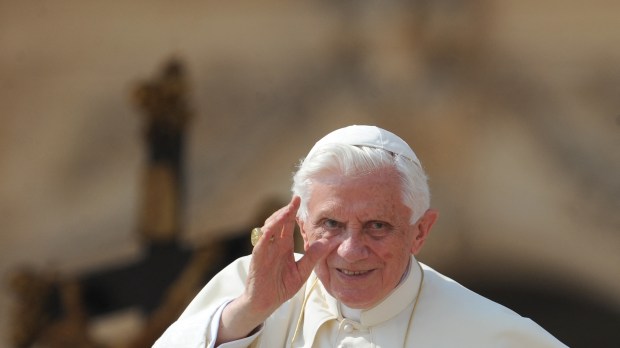 Pope Benedict XVI waves as he arrives for his weekly general audience